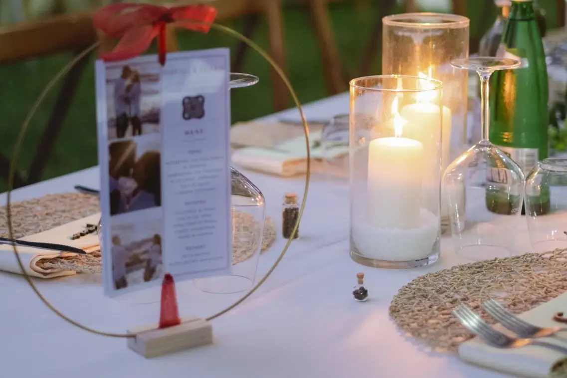 Table detail with candles and the wedding menu at a real wedding at Frà Viaco