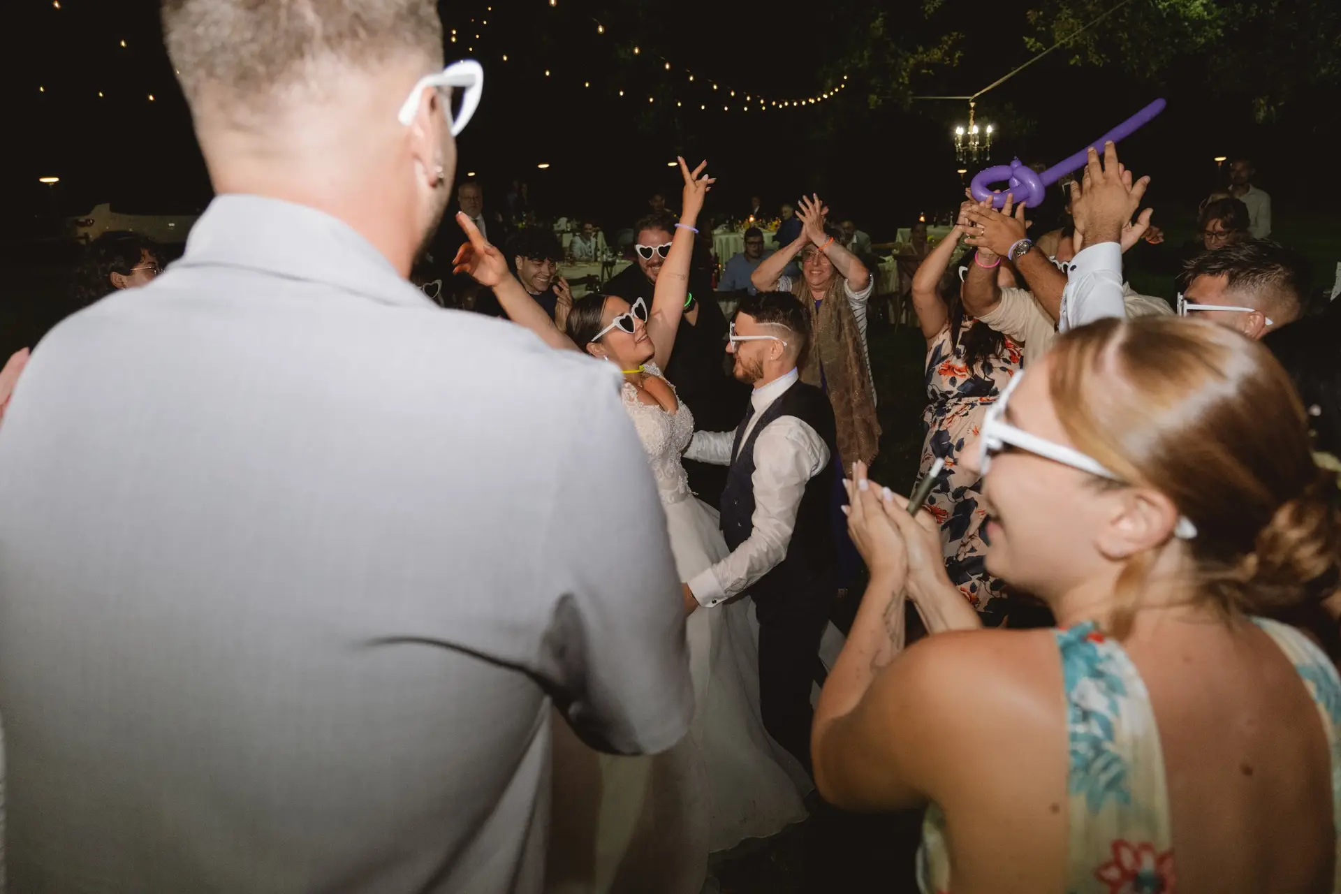 Dancing under the lights at the evening party of a real wedding at Frà Viaco
