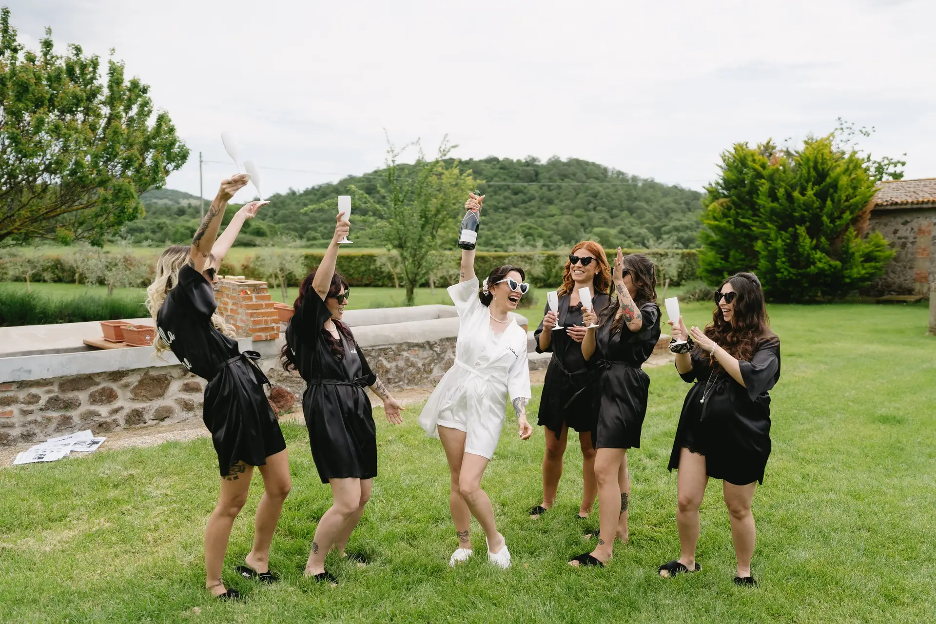 The bride and her friends raise a toast during the morning preparations at a real wedding at Frà Viaco