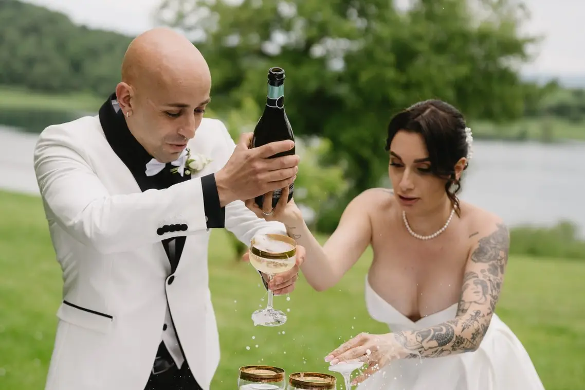 The newlyweds raise their glasses at the aperitivo overlooking Lago di Mezzano, at a real wedding at Frà Viaco